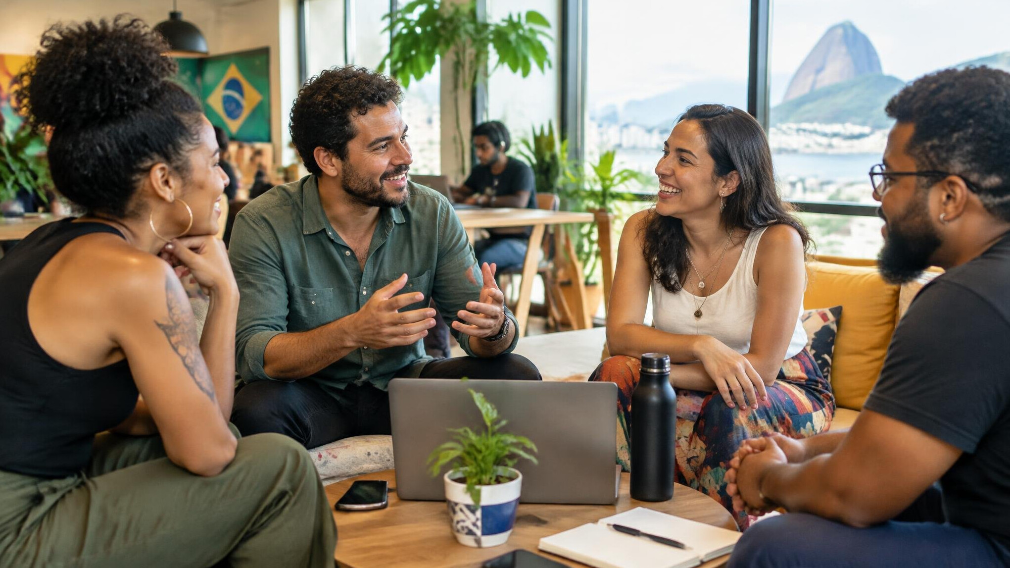 Group of diverse Brazilian colleagues having a friendly conversation in a bright office