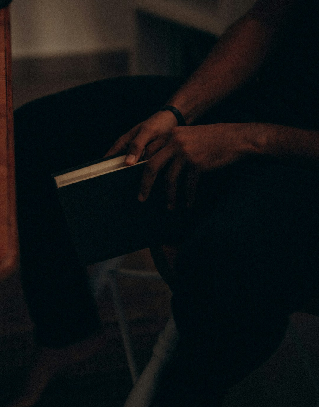 Brazilian man reading a book on personal development at home