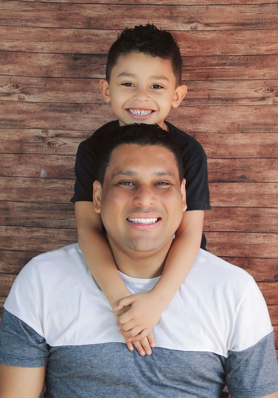 Studio portrait of a Brazilian man of East Asian descent smiling